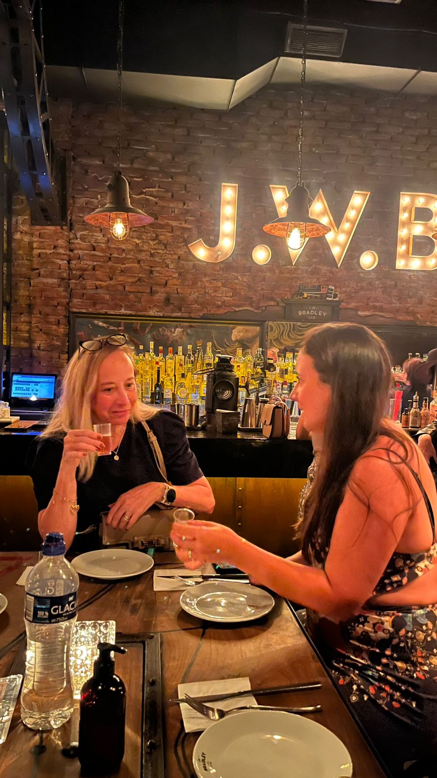 Guests sharing drinks at J.W. Bradley's vintage cocktail bar